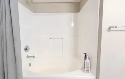 a white bathroom with a sink and a shower at Pacific Blue Townhome Walk to Ocean 2 Bed Apt WITH FREE PARKING in Los Angeles