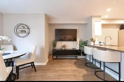 a kitchen and dining room with a sink and a table at Pacific Blue Townhome Walk to Ocean 2 Bed Apt WITH FREE PARKING in Los Angeles