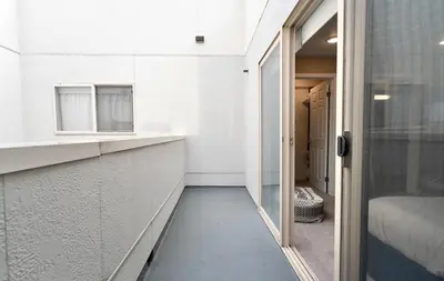 a room with a hallway with a door and a window at Pacific Blue Townhome Walk to Ocean 2 Bed Apt WITH FREE PARKING in Los Angeles