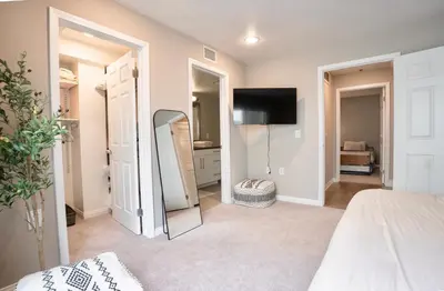 a bedroom with a mirror and a bed and a tv at Pacific Blue Townhome Walk to Ocean 2 Bed Apt WITH FREE PARKING in Los Angeles