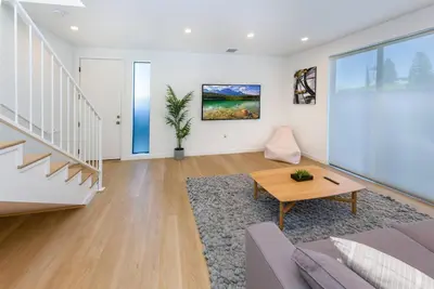 a living room with a couch and a table at Modern 2BR Back House w/ TVs & Full Kitchen in Los Angeles