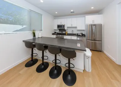 a kitchen with a black counter top in a room at Modern 2BR Back House w/ TVs & Full Kitchen in Los Angeles