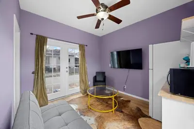 a living room with purple walls and a ceiling fan at Cozy Backhouse Stay – Sleeps 2 Beverly Hills Adj in Los Angeles