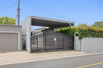 a driveway with a gate and a garage at Cozy Backhouse Stay – Sleeps 2 Beverly Hills Adj in Los Angeles