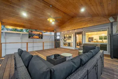 a living room with a large couch and a wooden ceiling at Lake Balboa Hideaway in Los Angeles