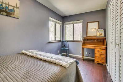 a bedroom with a bed and a desk and a piano at Partial Lake Arrowhead View Cabin with Game Room! in Lake Arrowhead