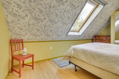 a bedroom with a bed and a window and a table at Partial Lake Arrowhead View Cabin with Game Room! in Lake Arrowhead