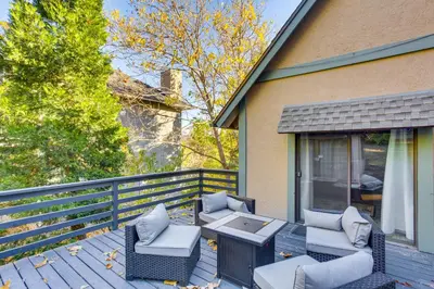 a patio with two chairs and a table on a house at Partial Lake Arrowhead View Cabin with Game Room! in Lake Arrowhead