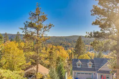 an aerial view of a house in the woods at Partial Lake Arrowhead View Cabin with Game Room! in Lake Arrowhead