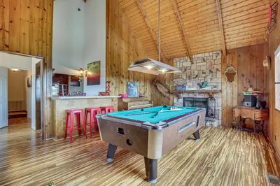 a pool table in the middle of a room at Partial Lake Arrowhead View Cabin with Game Room! in Lake Arrowhead