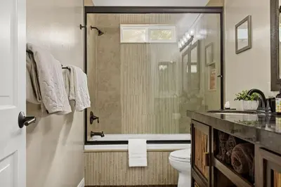 a bathroom with a shower and a toilet and a sink at Serenity Nook in Big Bear with a Hot Tub in Big Bear Lake