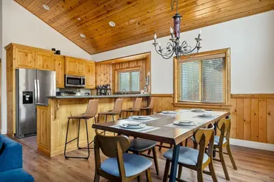 a dining room with a table and chairs in a kitchen at Llama Bear Lodge with Hot Tub in Big Bear Lake