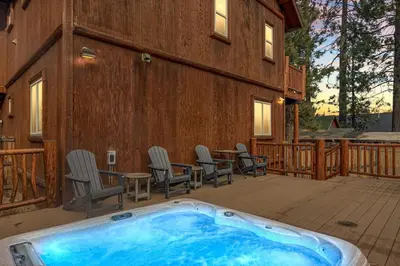 a hot tub on the patio of a house at Llama Bear Lodge with Hot Tub in Big Bear Lake