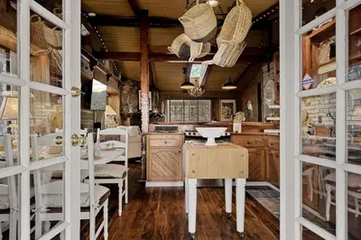 a kitchen with wooden cabinets and a table and chairs at Eureka Ranch Designer Cabin in Big Bear Lake