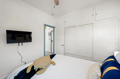 a bedroom with a stuffed animal sitting on a bed at Luxury Beachside Gem Walk to Beach Ocean Views in Manhattan Beach