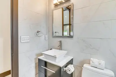a white bathroom with a sink and a toilet at Private Pool and Sauna Pet-Friendly Reseda Retreat! in Reseda