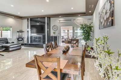 a dining room and living room with a table and chairs at Private Pool and Sauna Pet-Friendly Reseda Retreat! in Reseda
