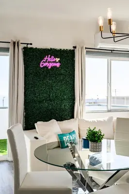 a living room with a white couch and a glass table at Newly Remodeled Cozy Beach Retreat Ocean Views in Manhattan Beach