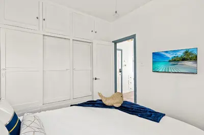 a bedroom with a bed with a teddy bear on it at Newly Remodeled Cozy Beach Retreat Ocean Views in Manhattan Beach