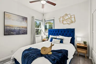 a bedroom with a bed with a stuffed animal on it at Newly Remodeled Cozy Beach Retreat Ocean Views in Manhattan Beach