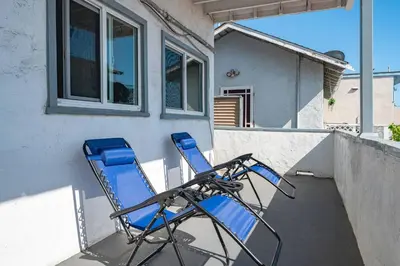 a pair of blue chairs sitting on a porch at 2BR Luxury Getaway Mins to Beach Arcade & Games in Manhattan Beach