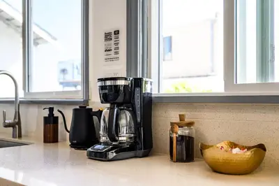 a kitchen counter with a coffee maker and a banana on the counter at 2BR Luxury Getaway Mins to Beach Arcade & Games in Manhattan Beach