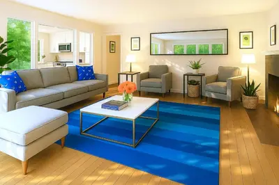 a living room with a couch and a blue rug at Enchanting Hollywood Hills Oasis with Tree-Top Views, Serene Outdoor Living Room, Zen Garden, Free Attached Garage, Sleeps 6, in LA's Most Desirable, Central, Serene Canyon Neighborhood, and Only 2 Minutes to Hollywood Boulevard in Los Angeles