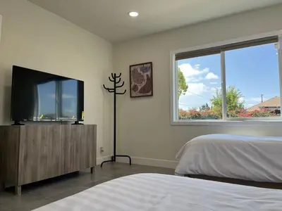 a bedroom with a bed and a flat screen tv at Gated & remodeled 2b2b house 3373 in Baldwin Park
