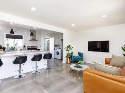 a living room with a couch and a kitchen at Gated & remodeled 2b2b house 3373 in Baldwin Park