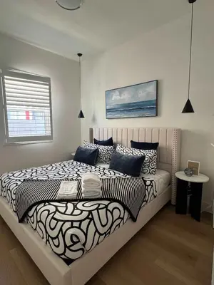 a bedroom with a large bed and a window at #Marbella Lane - Stylish Haven Near City Center in Long Beach