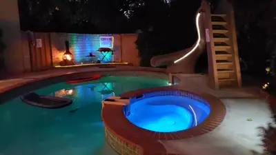 a swimming pool at night with a blue pool at Cozy Guesthouse with Private Pool and Heated Jacuzzi in Santa Clarita