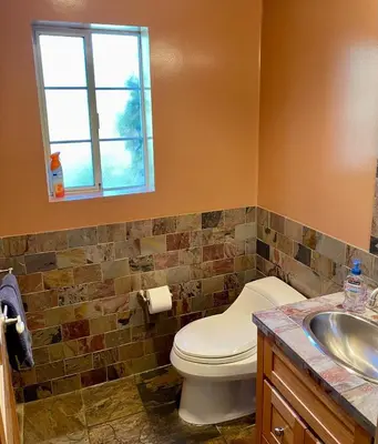 a bathroom with a toilet and a sink at Cozy Guesthouse with Private Pool and Heated Jacuzzi in Santa Clarita