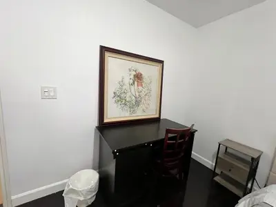 a black desk with a picture on the wall at Near Disney,college,sunset beach ,airport in Norwalk