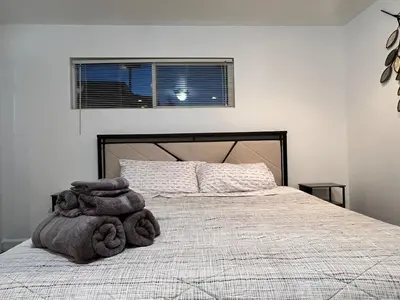 a bedroom with a large bed and a window at Near Disney,college,sunset beach ,airport in Norwalk