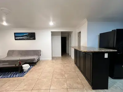 a living room with a bed and a counter at Near Disney,college,sunset beach ,airport in Norwalk