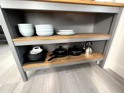 a shelf with plates and bowls and utensils at Gated & Morden 1bed1bath house3367 in Baldwin Park