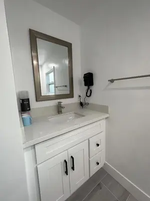 a bathroom with a white sink and a mirror at Gated & Morden 1bed1bath house3367 in Baldwin Park