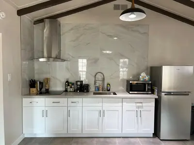 a kitchen with white cabinets and a stainless steel refrigerator at Fully Remodeled 2B1B Home in Baldwin3369 in Baldwin Park