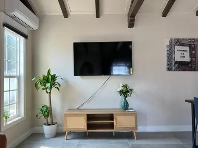 a living room with a flat screen tv on a wall at Fully Remodeled 2B1B Home in Baldwin3369 in Baldwin Park