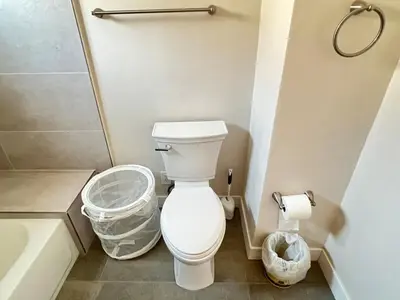 a bathroom with a toilet and a trash can at Fully remoded 1B1B Home in baldwin Park3369A in Baldwin Park