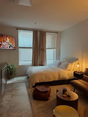 a bedroom with a large bed and a living room at Elegant Suite at Marina-Venice Beach with Pool, Jacuzzi, GYM by Holisticā Retreats in Los Angeles