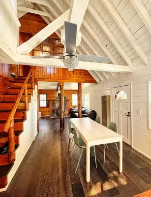 a dining room with a table and a vaulted ceiling at Cozy Crestline Cabin Getaway in Crestline