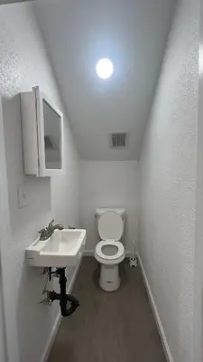 a small bathroom with a toilet and a sink at Naryn Guest house in Los Angeles