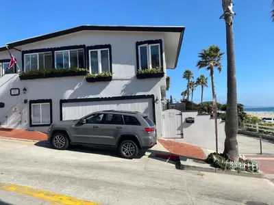 a car parked in front of a house at Manhattan Beach Beachfront Charming On The Strand in Manhattan Beach