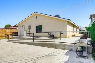 a building with a fence in front of it at 1 Mi to Rabobank Arena Home with Gazebo! in Bakersfield