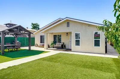 a house with a patio and a grass yard at 1 Mi to Rabobank Arena Home with Gazebo! in Bakersfield