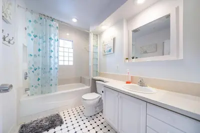 a white bathroom with a sink and a toilet and a tub at 40 ppl 2 houses 13 Bedrooms btw Disney Hollywd in Monterey Park
