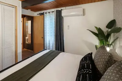 a bedroom with a bed and a window at Sequoia A-frame Nirvana: Modern + Views + Hot Tub in Ponderosa