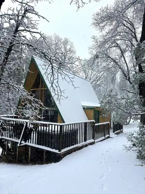 a snow covered house with a snow covered roof at Sequoia A-frame Nirvana: Modern + Views + Hot Tub in Ponderosa