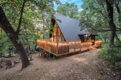 a house clad in wood with a metal roof at Sequoia A-frame Nirvana: Modern + Views + Hot Tub in Ponderosa